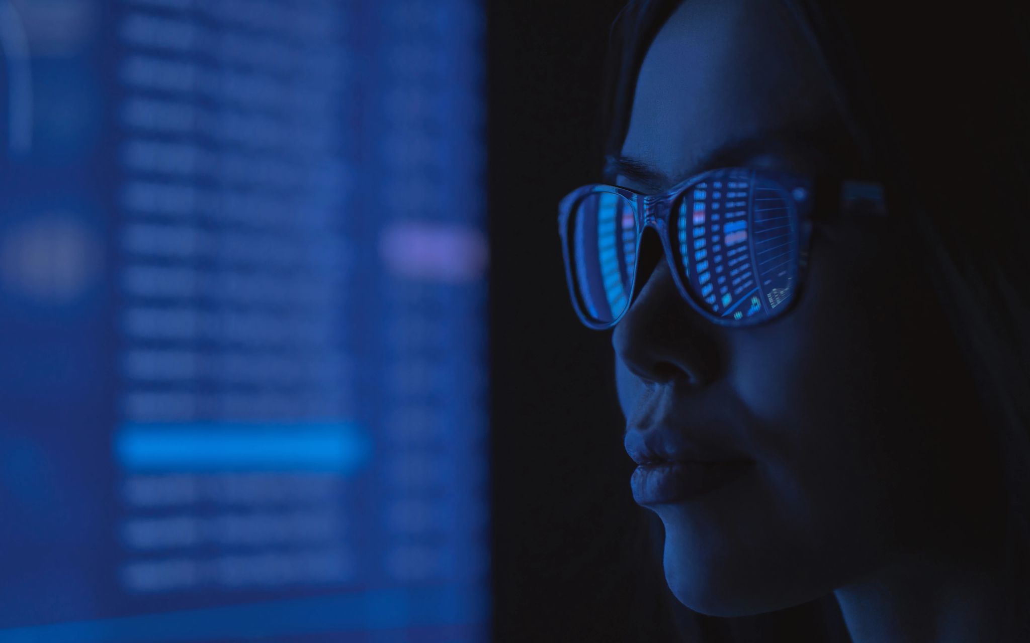 Woman in glasses viewing a computer screen