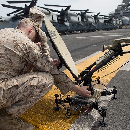 Two warfighters setting up Viasat's Multi-Mission SATCOM Terminal